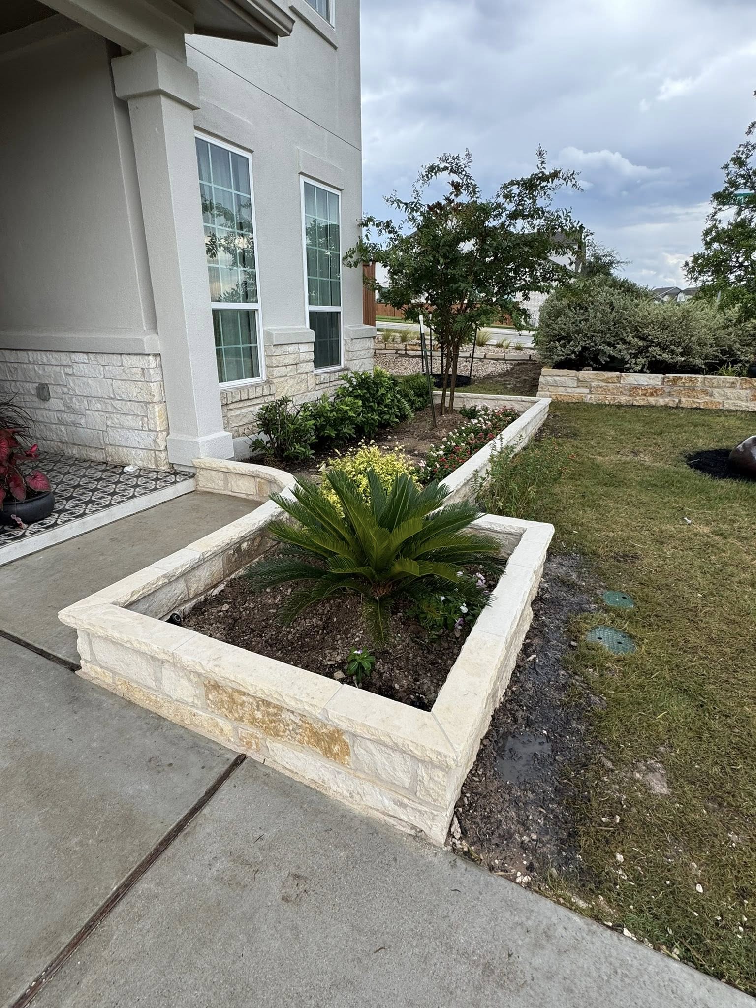 Completed landscape installation with flowerbeds and lighting